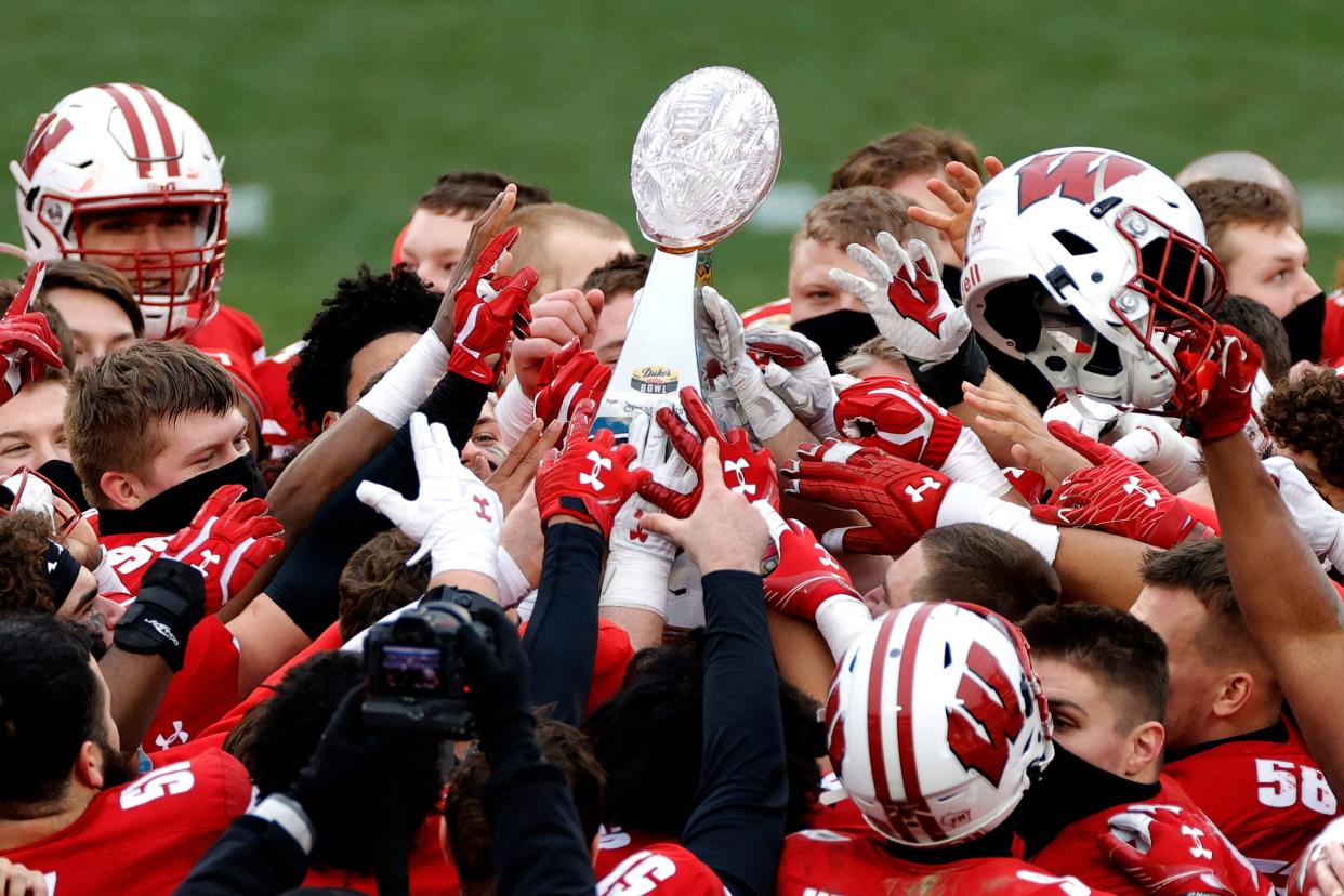 The Wisconsin Badgers celebrate their victory over the Wake Forest Demon Deacons after winning the Duke's Mayo Bowl in Charlotte Wednesday afternoon.