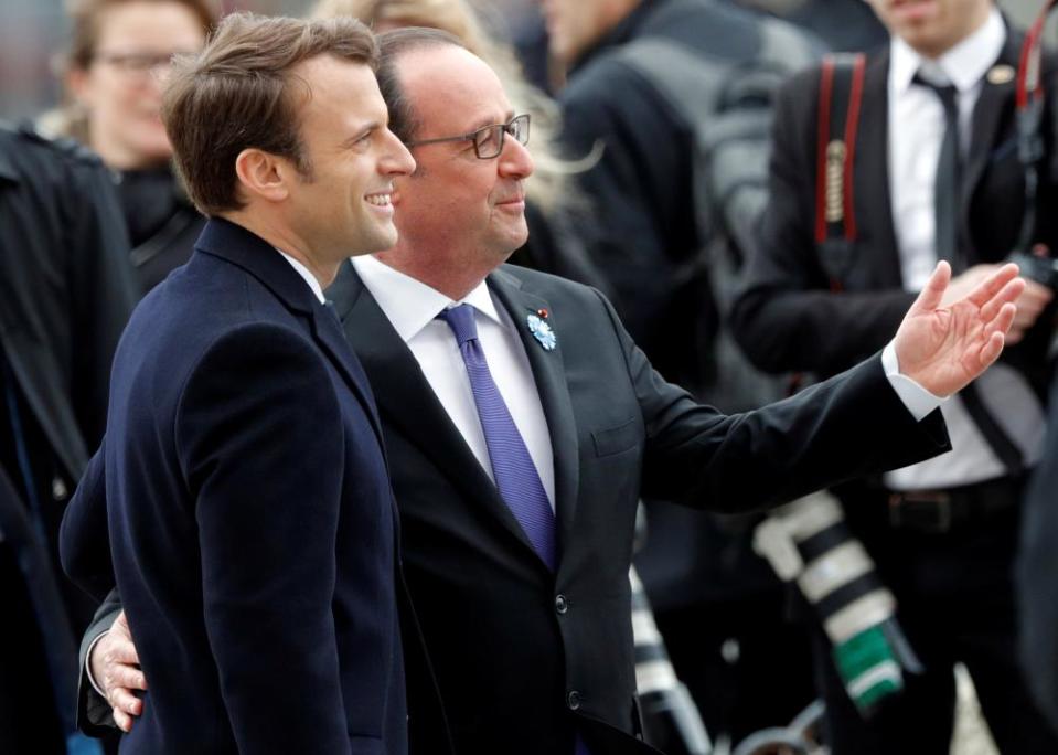 Macron and Hollande attend a ceremony at the Arc de Triomphe in Paris on Monday.