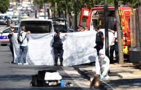 <p>A white sheet is erected as a body of a victim is evacuated to a waiting ambulance while French forensic police officer search the site following a car crash on Aug. 21, 2017, in the southern Mediterranean city of Marseille. (Photo: Boris Horvat/AFP/Getty Images) </p>