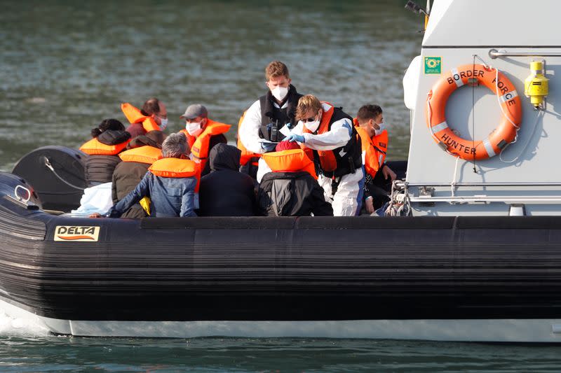 Border Force crew attend migrants in a Border Force boat at Dover harbour