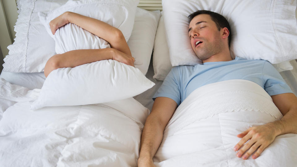 couple in bed, man snoring