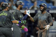 Tampa Bay Rays' Randy Arozarena, right, celebrates his two-run home run off Chicago White Sox starting pitcher Michael Soroka with Amed Rosario, center, and Isaac Paredes, left, during the third inning of a baseball game Tuesday, May 7, 2024, in St. Petersburg, Fla. (AP Photo/Chris O'Meara)