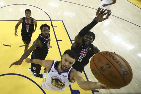 April 13, 2019; Oakland, CA, USA; Golden State Warriors guard Stephen Curry (30) shoots the basketball against LA Clippers forward Montrezl Harrell (5) during the first half in game one of the first round of the 2019 NBA Playoffs at Oracle Arena. Mandatory Credit: Ezra Shaw/Pool Photo via USA TODAY Sports