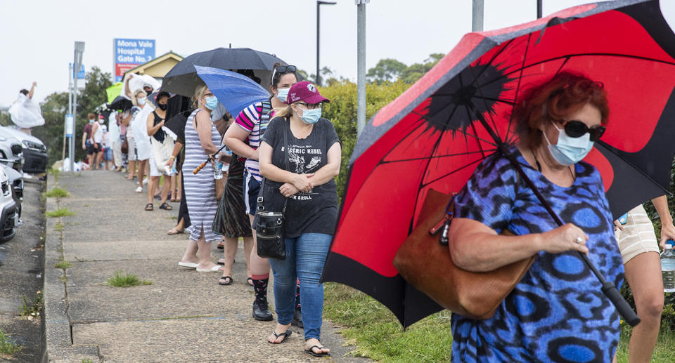 SYDNEY, AUSTRALIA - DECEMBER 18: People are seen lining up at a COVID-19 testing site at Mona Vale Hospital on December 18, 2020 in Sydney, Australia.A cluster of Covid-19 cases on the northern beaches of Sydney has grown to 28, prompting NSW health officials to urge residents of affected suburbs to stay home. Traffic at Sydney Airport has increased as people rush to leave the city with several states imposing quarantine restrictions for New South Wales residents. (Photo by Jenny Evans/Getty Images)