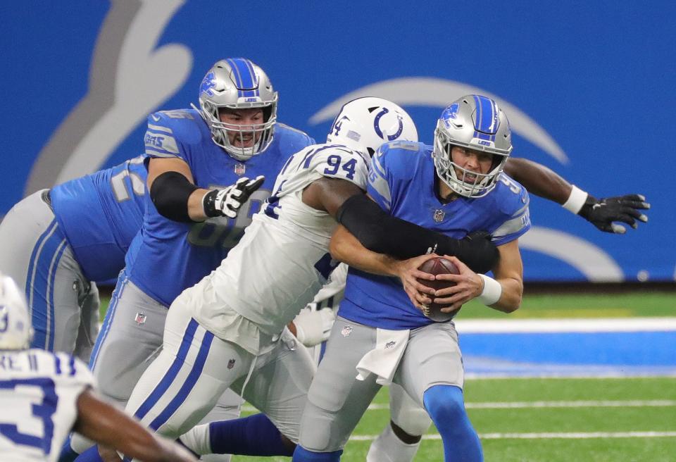 Lions quarterback Matthew Stafford is sacked by Colts defensive end Tyquan Lewis during the first half on Sunday, Nov. 1, 2020, at Ford Field.