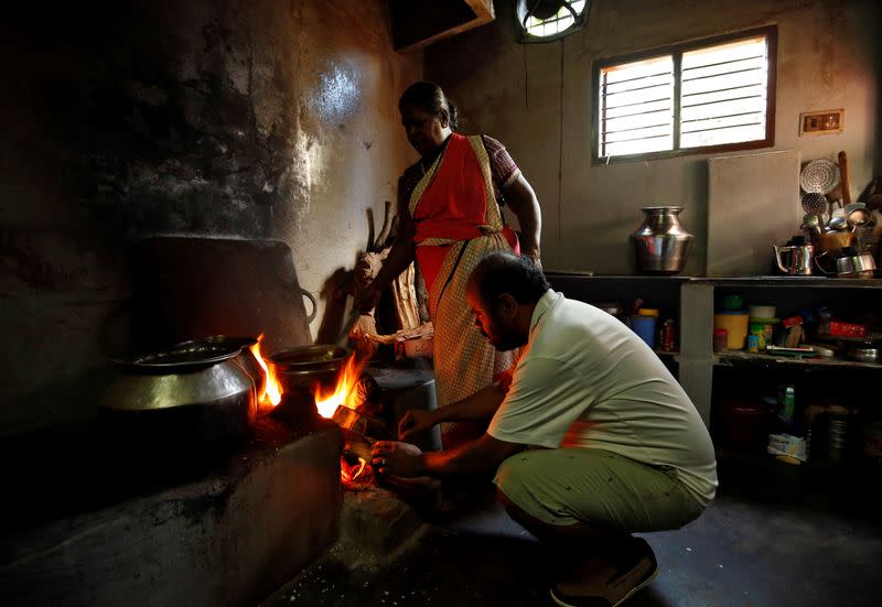 Karibeeran Paramesvaran, who lost three children in the 2004 tsunami, helps cook food inside his house that he has turned into a care home for orphaned children in Nagapattinam district in the southern state of Tamil Nadu, India