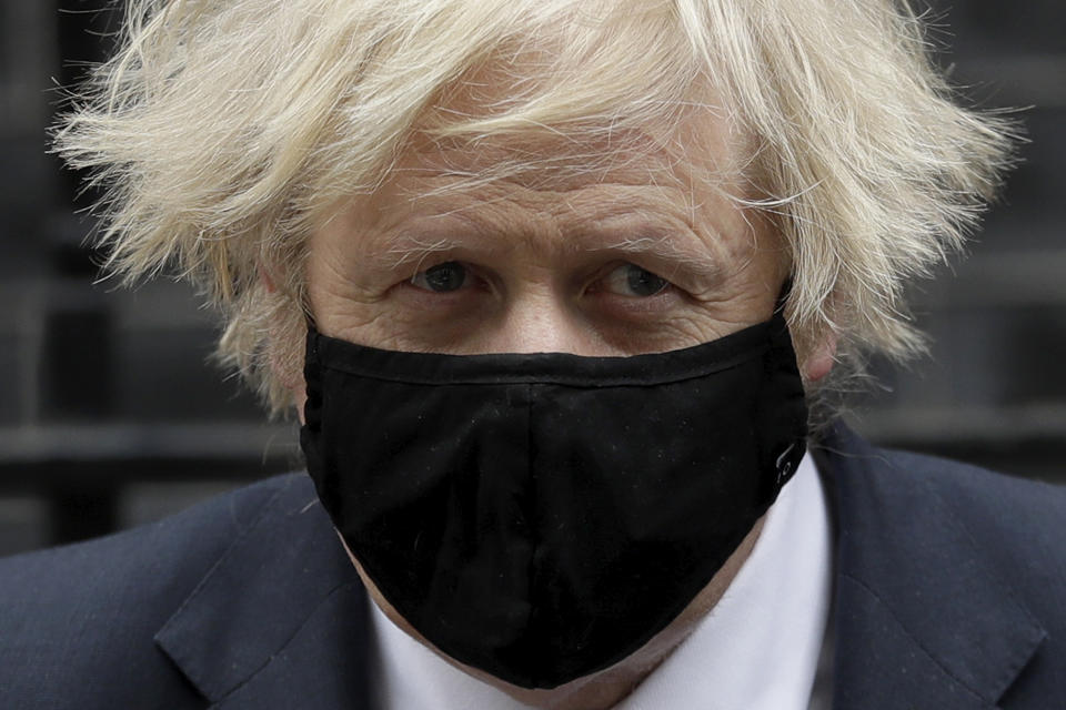 British Prime Minister Boris Johnson leaves 10 Downing Street in London, to attend the weekly Prime Minister's Questions at the Houses of Parliament, in London, Wednesday, March 24, 2021. (AP Photo/Matt Dunham)