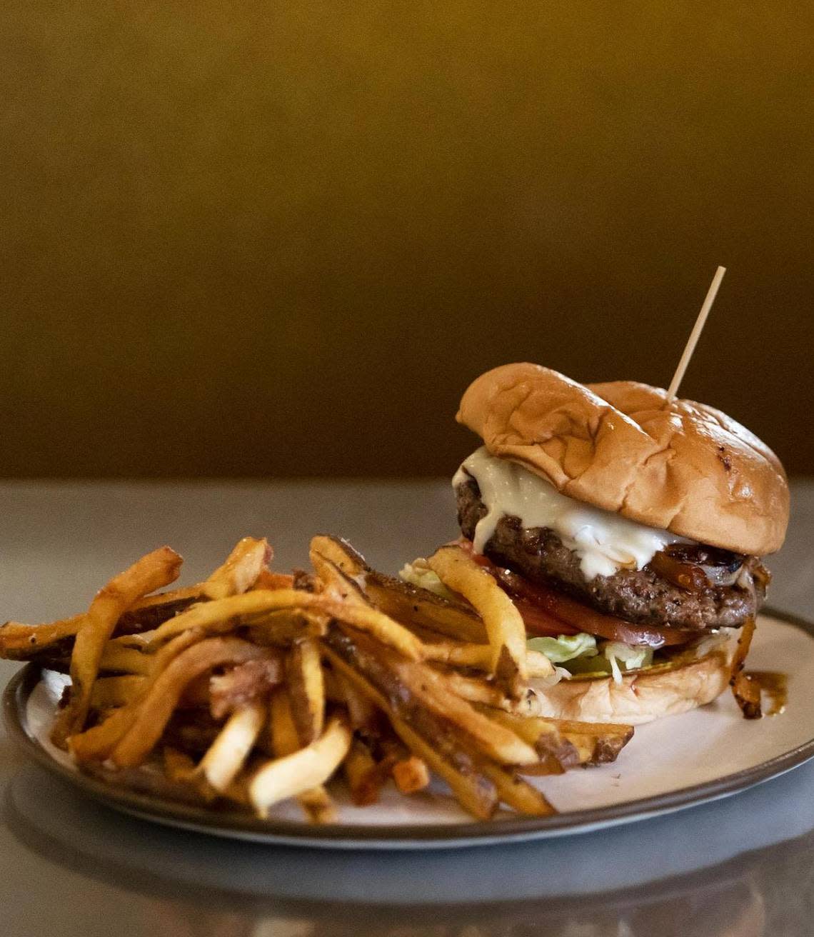 The Diablo burger at Fred’s Texas Cafe on Friday, June 17, 2022. The Diablo burger, one of Fred’s iconic menu items, features chipotle brown butter, grilled onions, Swiss cheese, pickles, lettuce, tomato and mustard. Amanda McCoy/amccoy@star-telegram.com