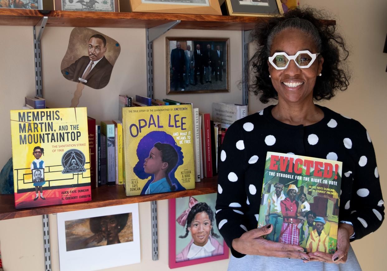 Alice Faye Duncan poses with her books Wednesday, Feb. 9, 2022, at her home in Memphis.