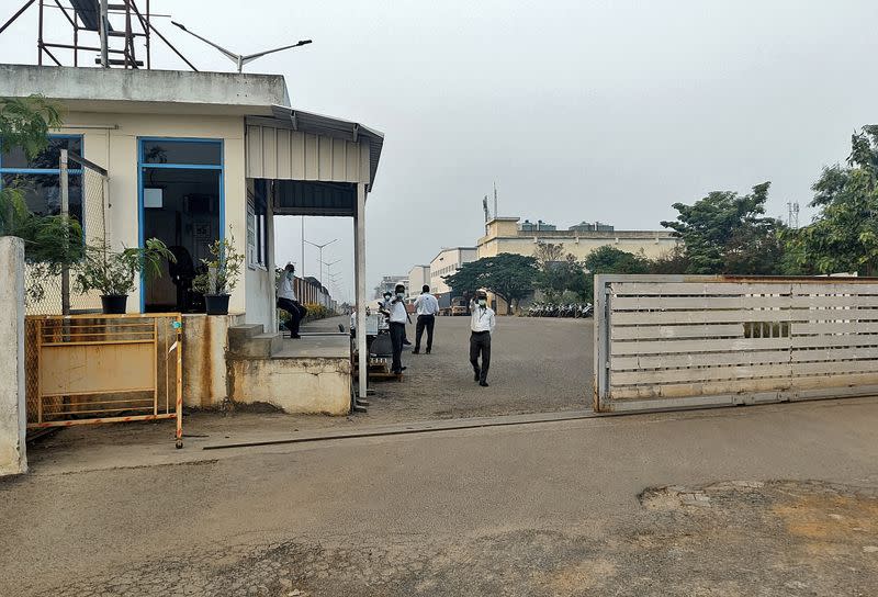 FILE PHOTO: Private security guards stand at the entrance of a closed plant of Foxconn India, near Chennai