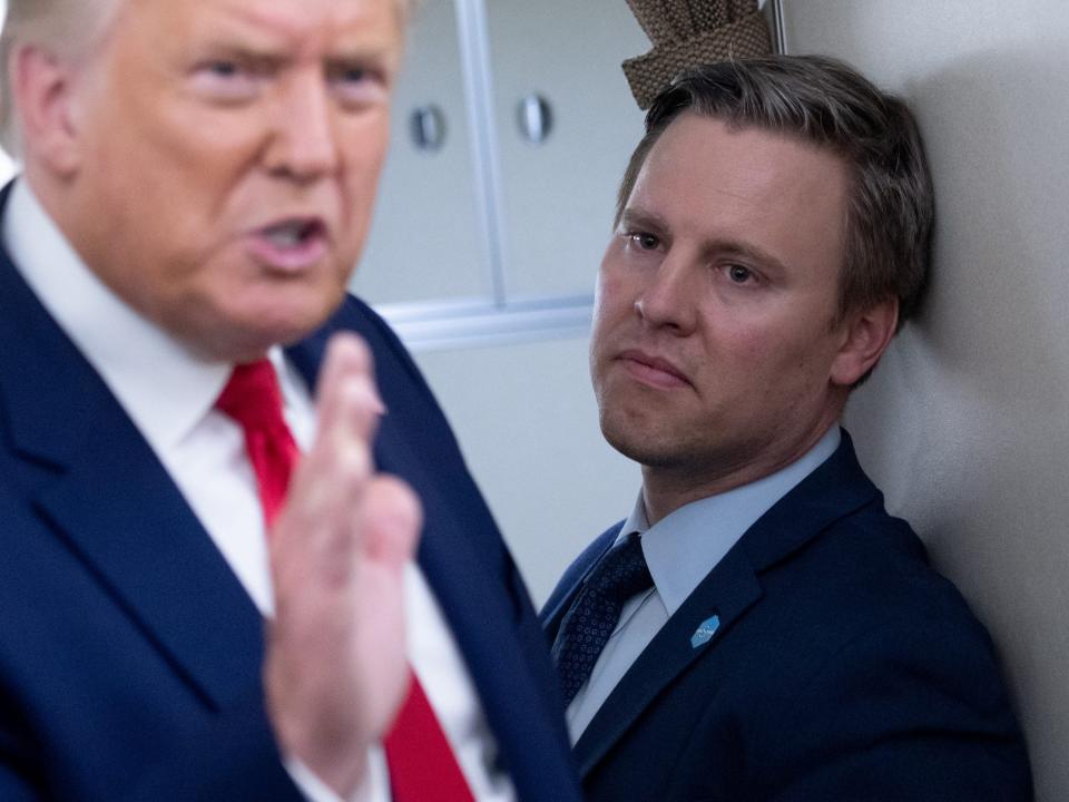 Trump campaign manager Bill Stepien looks at then-US President Donald Trump as he addresses reporters during a flight on Air Force One.