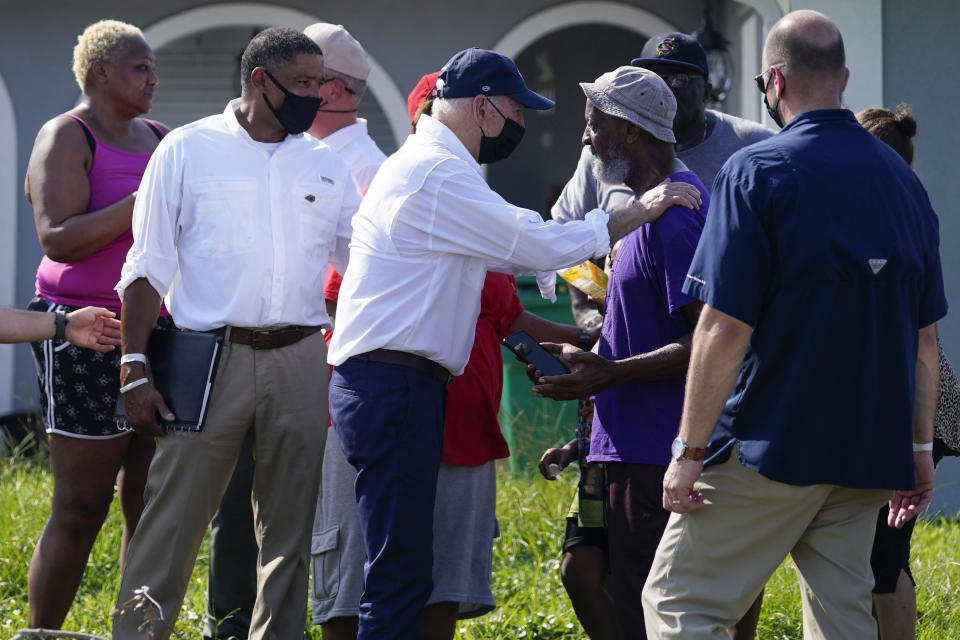 President Joe Biden talks as he tours a neighborhood impacted by Hurricane Ida, Friday, Sept. 3, 2021, in LaPlace, La. (AP Photo/Evan Vucci)