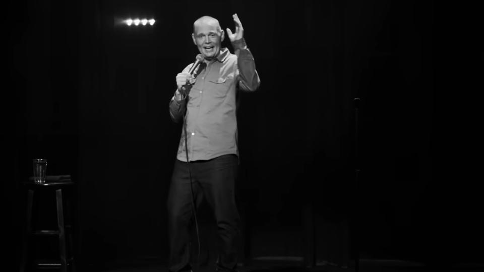 Bill Burr in a black and white screenshot on stage