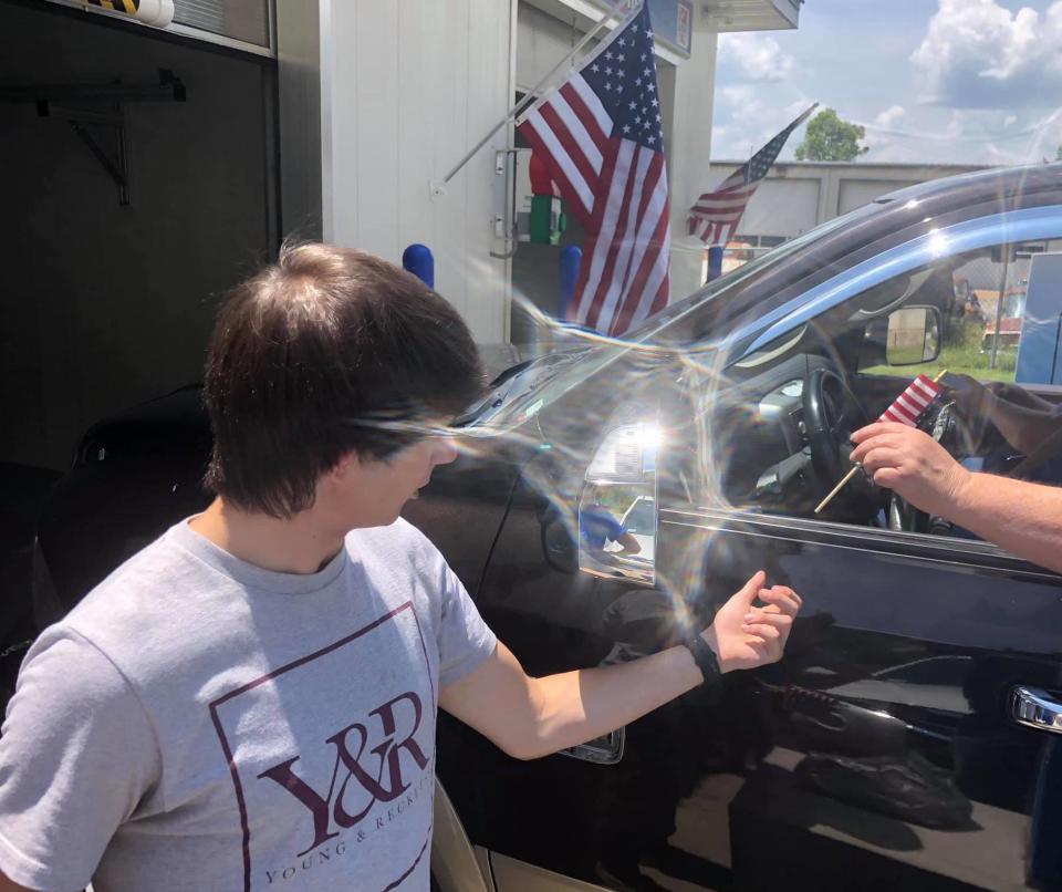 Nineteen-year-old Keaton Chandler stole an American flag from a Missouri carwash and as punishment, handed out mini versions to customers. (Photo: Courtesy of Bill Hoaglin)