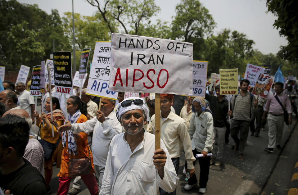 An activist of All India Peace and Solidarity Organization, AIPSO, a left-wing organization, holds a placard during a protest against the upcoming visit of U.S. Secretary of State Mike Pompeo to India, in New Delhi, India, Tuesday, June 25, 2019. Pompeo is scheduled to travel to India after having visited Saudi Arabia and the United Arab Emirates, on a trip aimed at building a global coalition to counter Iran. (AP Photo/Altaf Qadri)