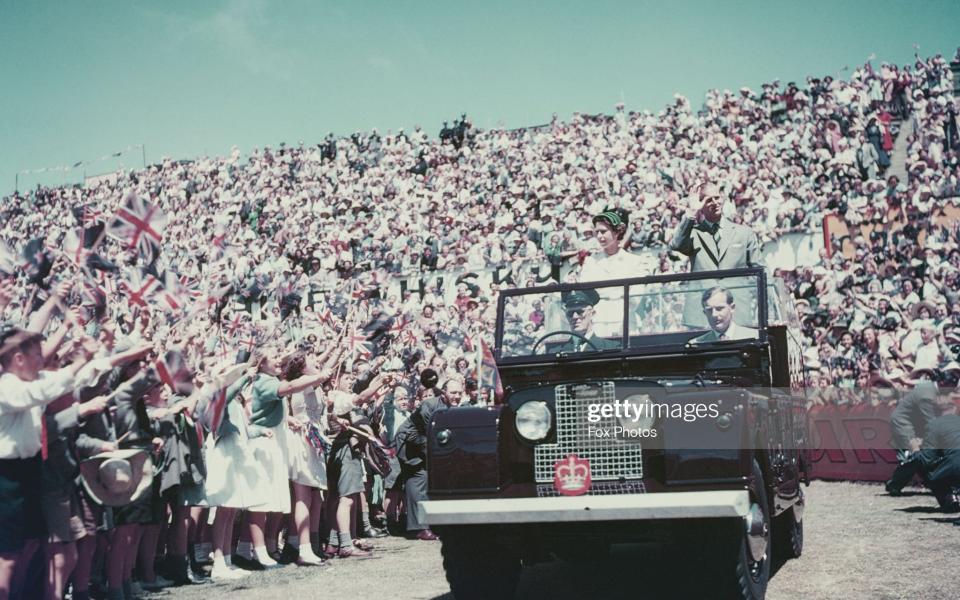 Queen Elizabeth II and Prince Philip wave to the crowd whilst on their Commonwealth visit to Australia, 1954 - Fox Photos /2013 Getty Images 