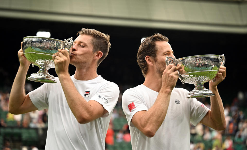 Neal Skupski and Wesley Koolhof celebrate with their trophies after winning the men's doubles final against Spain's Marcel Granollers and Argentina's Horacio Zeballos (REUTERS/Dylan Martinez)