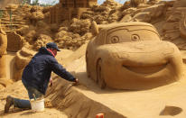 BLANKENBERGE, BELGIUM - JULY 22: A sand sculpture artist works during the Sand Sculpture Festival with Sand Sculptures based on the Magical Moments Festival of Disneyland Paris on July 22, 2011 in Blankenberge, Belgium. (Photo by Mark Renders/Getty Images)