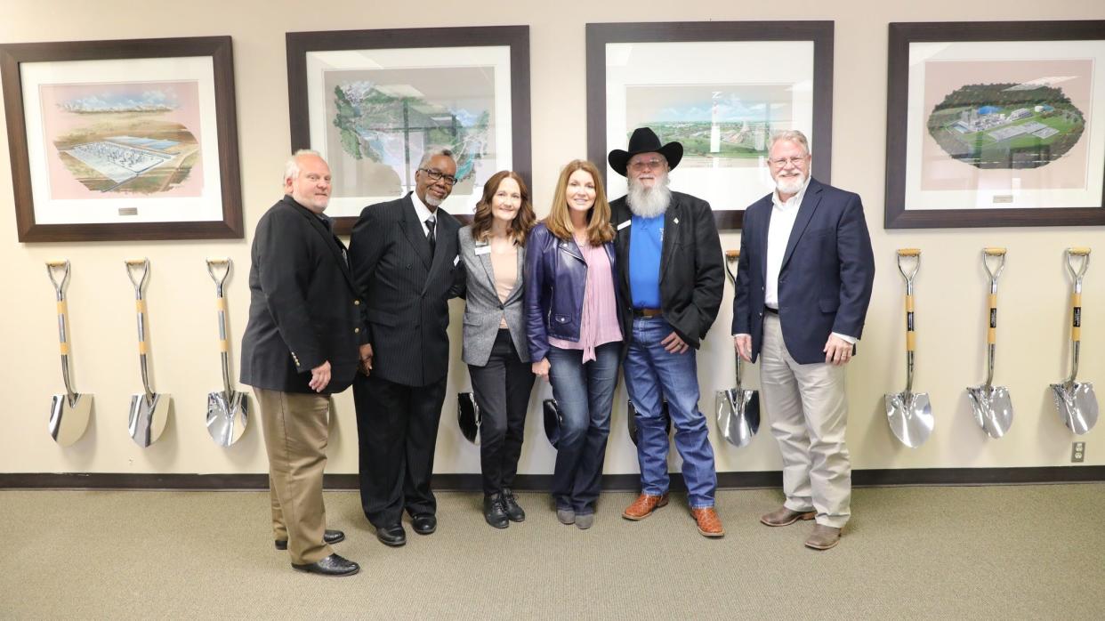 Dixie Carter, center in dark blue jacket, poses with Wichita Falls community leaders during a tour of the Panda Biotech plant in April. Carter will ask the city for an extension on its hiring promise.