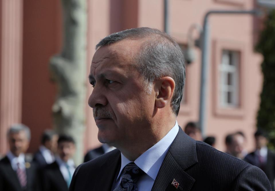 Turkish Prime Minister Recep Tayyip Erdogan walks outside his office in Ankara, Turkey, Thursday, April 17, 2014. Turkey's parliament looks set to pass a bill that increases the powers and immunities of the country's spy agency. It is the latest in a string of moves critics say is undermining democracy in the country that is a candidate to join the European Union. The bill, expected to be voted on Thursday, gives the National Intelligence Agency greater eavesdropping and operational powers and increases its immunities and abilities to keep tabs on citizens. Journalists publishing classified documents would face prison terms. (AP Photo/Burhan Ozbilici)