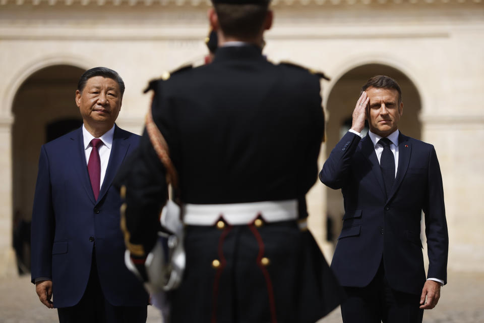 French President Emmanuel Macron and Chinese President Xi Jinping stand in front of the Republican Guards during the official welcoming ceremony at the Hotel national des Invalides in Paris, Monday, May 6, 2024. China's President Xi Jinping is in France for a two-day state visit that is expected to focus both on trade disputes and diplomatic efforts to convince Beijing to use its influence to move Russia toward ending the war in Ukraine.(Yoan Valat, Pool via AP)