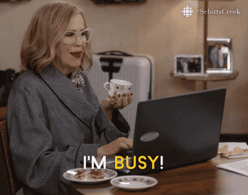 Moira Rose from Schitt's Creek saying "I'm busy" in front of a laptop