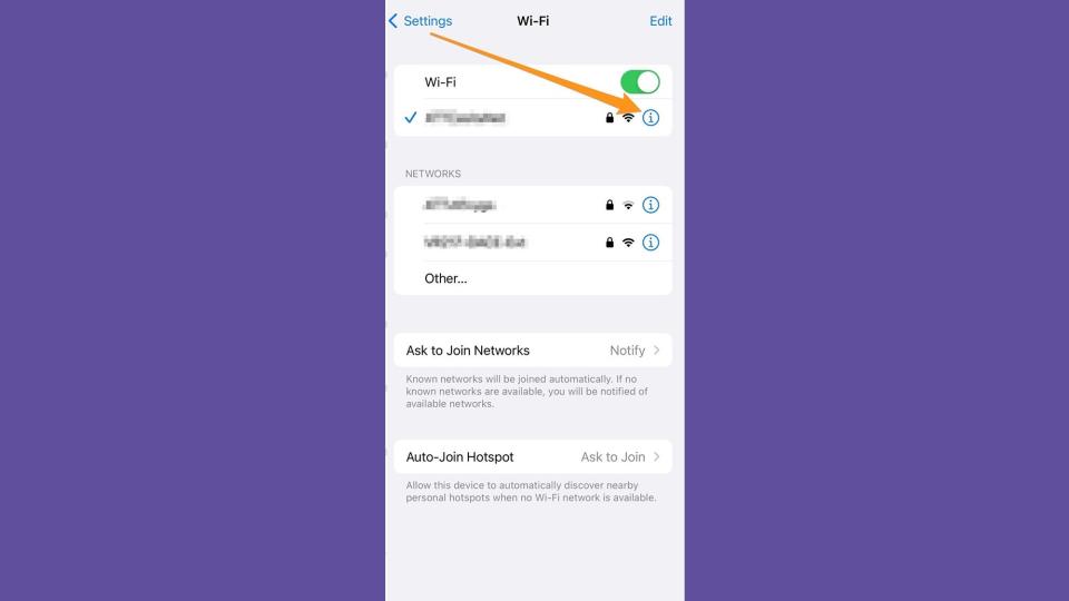The arrow is pointing at the blue information button, which is a circle with an I inside in the WiFi settings of an iPhone.