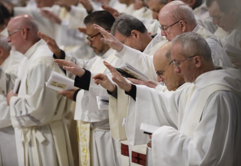 Priests receive the blessing during a Chrism Mass celebrated by Pope Francis inside St. Peter's Basilica, at the Vatican, Thursday, April 18, 2019. During the Mass the Pontiff blesses a token amount of oil that will be used to administer the sacraments for the year. (AP Photo/Alessandra Tarantino)
