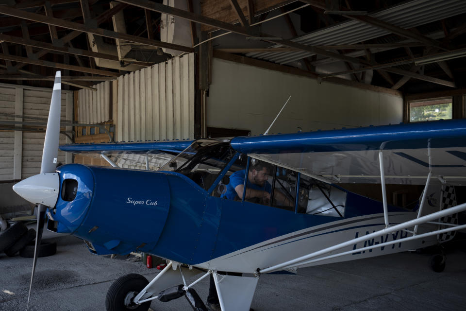 Garrett Fisher, an American aviator and adventurer, prepares his plane before take-off in Voss, Norway, on July 29, 2022. Many glaciers are remote and hard to reach or document – except by satellite or by air, making the tiny Super Cub the perfect vehicle for this photographic journey. It is built to navigate the blustery winds and dangerous environments necessary for his work. (AP Photo/Bram Janssen)