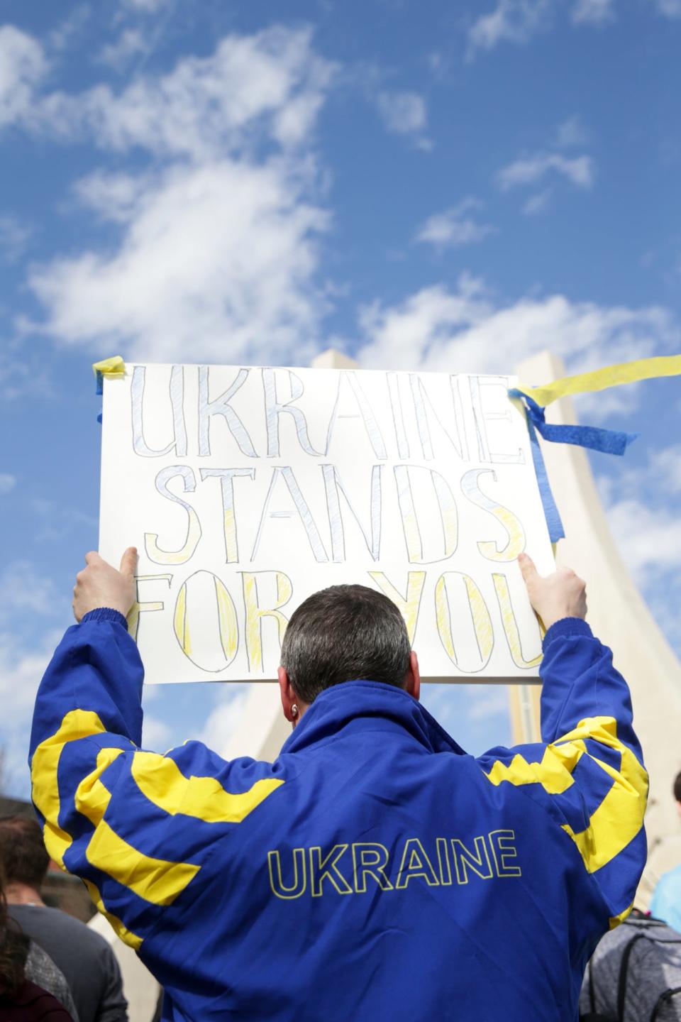 A man holds a "Ukraine stands for you" sign during a rally at Purdue University against Russia's invasion of Ukraine, Wednesday, March 2, 2022 in West Lafayette.