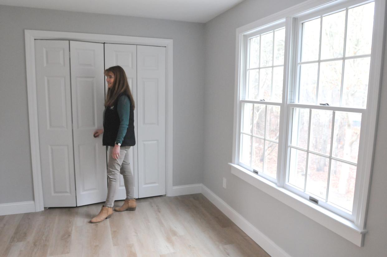 Inside one of the second-floor bedrooms, Brewster Housing Coordinator Jill Scalise shows some of the features of the renovated affordable home at 212 Yankee Drive. Town officials have renovated this once-abandoned house and preserved it as affordable housing. The three-bedroom home is for sale and the new owners will be chosen by lottery.
