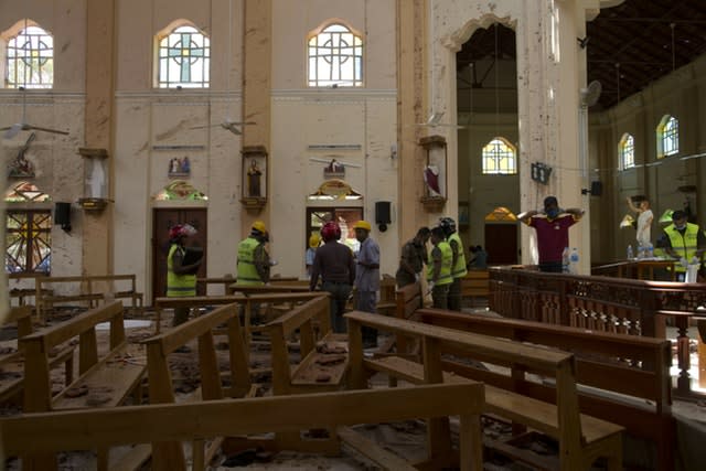 Investigators at the scene of a suicide bombing at St Sebastian Church in Negombo, Sri Lanka