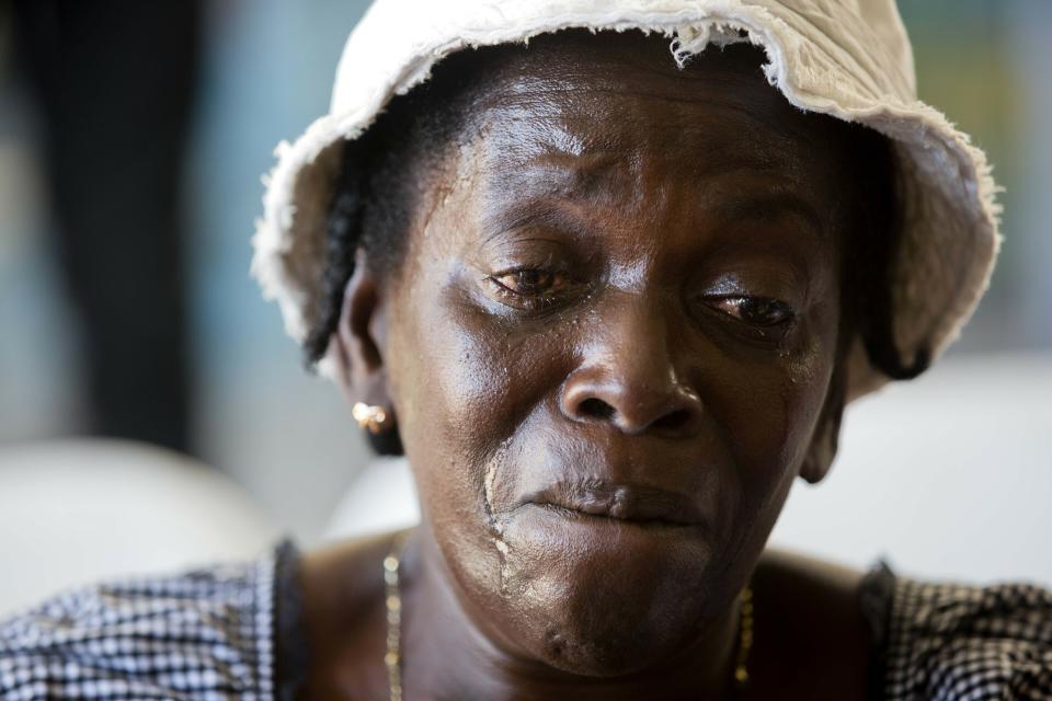 In this Dec. 13, 2018 photo, Jeannette Jasmin, mother of 21-year-old Claudy Thomas, who Jasmine said was killed during a massacre that killed at least 20 people in the La Saline slum, cries during a memorial for the victims in Port-au-Prince, Haiti. Victims were shot or hacked with machetes and only eight full bodies had been recovered for burial because most had been burned or fed to pigs, according to Raphael Louigene, social-work coordinator for a charity that works in the slums. (AP Photo/Dieu Nalio Chery)