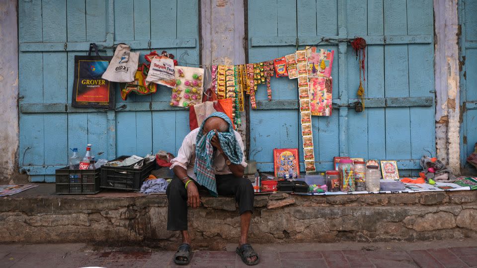A man wipes his face during a hot day in New Delhi on April 21, 2024. - Noemi Cassanelli/CNN