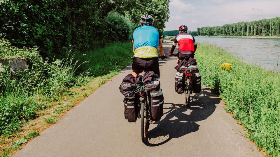 Bikepackers riding beside canal