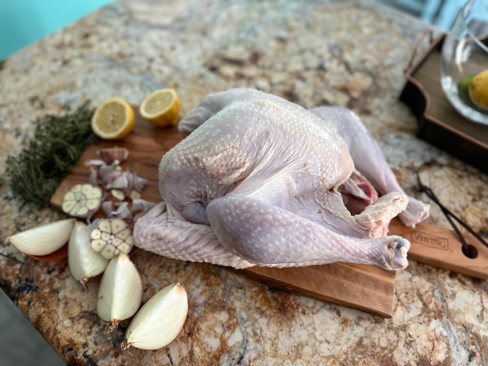 Uncooked turkey on wooden cutting board