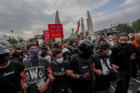 Front line pro-democracy protesters lead a march with linked-arms at Democracy Monument in Bangkok, Thailand, Sunday, Nov. 8, 2020. The protesters continue to gather Sunday, led by their three main demands of Prime Minister Prayuth Chan-ocha's resignation, changes to a constitution that was drafted under military rule and reforms to the constitutional monarchy. (AP Photo/Sakchai Lalit)