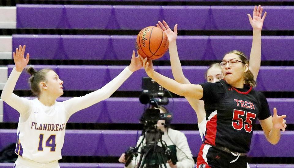 Flandreau's Hannah Krull (14) and Lakota Tech's Melina Shangreaux battle for the ball during their consolation semifinal game in the state Class A high school girls basketball tournament on Friday, March 10, 2023 in the Watertown Civic Arena.