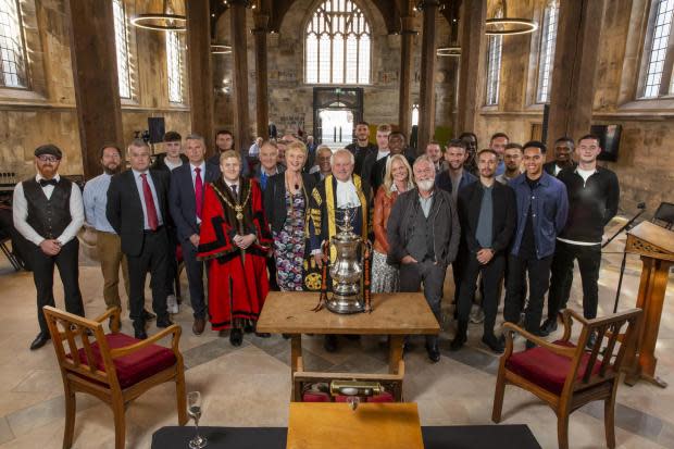 The the Civic Party, representatives and players from York City Football Club and Councillor Nigel Ayre celebrate the club's victory