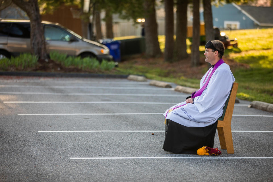 Father Holmer says that only rain will stop him from setting up to hear confessions in the church parking lot.  (Andrew Biraj/ Catholic Standard newspaper / adw.org)
