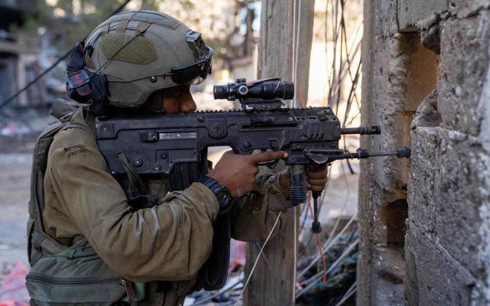 An Israeli soldier takes position in a location given as Gaza