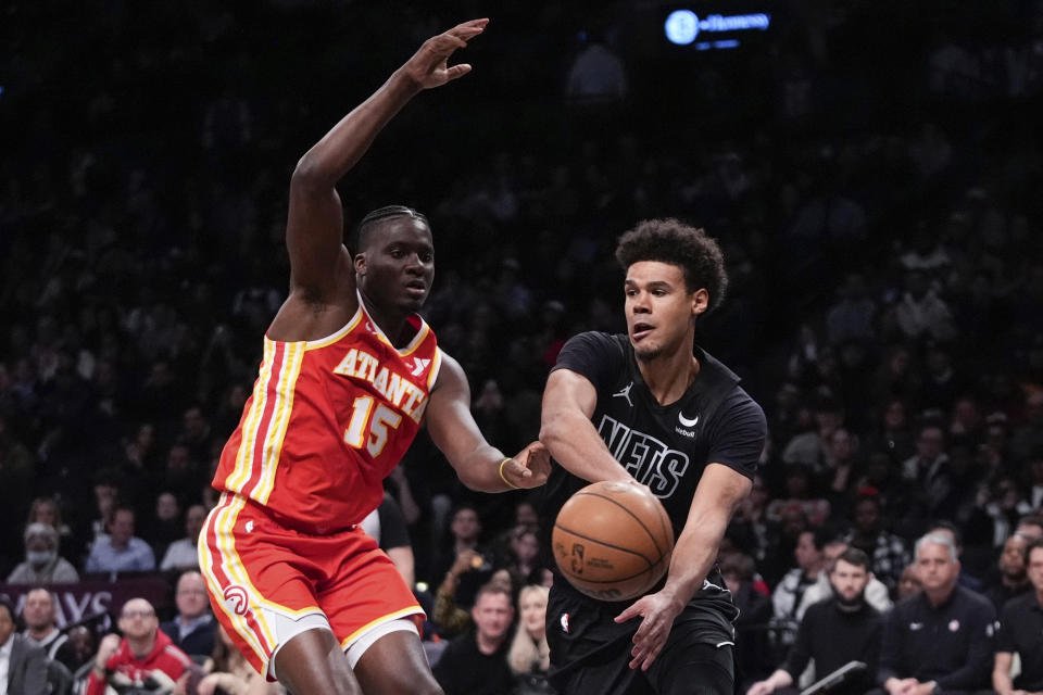 Brooklyn Nets' Cameron Johnson, right, passes the ball away from Atlanta Hawks' Clint Capela (15) during the second half of an NBA basketball game Thursday, Feb. 29, 2024, in New York. (AP Photo/Frank Franklin II)