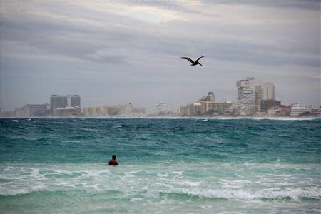 A man swims in the ocean in Cancun October 3, 2013. REUTERS/Victor Ruiz Garcia