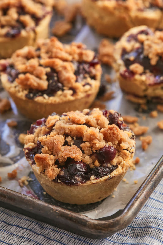 <p>Bigger Bolder Baking</p><p>These blueberry crumb pies have a juicy blueberry filling, delicious pie crust bottom, and an irresistible cinnamon crumb topping.</p><p><strong>Get the recipe: <a href="https://www.biggerbolderbaking.com/individual-blueberry-crumb-pies/" rel="nofollow noopener" target="_blank" data-ylk="slk:Mini Blueberry Crumb Pies;elm:context_link;itc:0;sec:content-canvas" class="link ">Mini Blueberry Crumb Pies</a></strong></p>