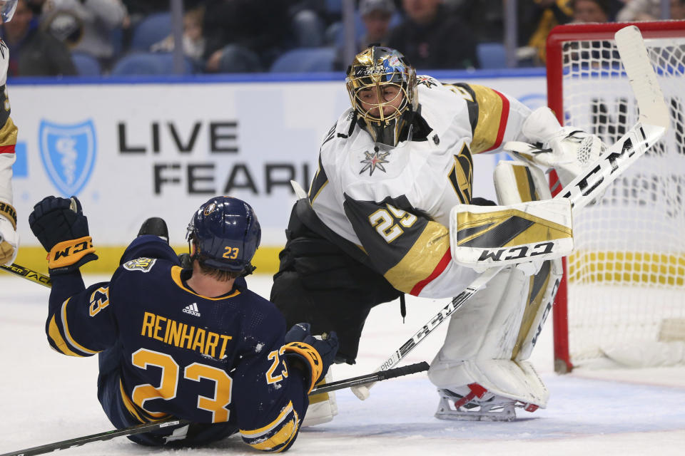 Buffalo Sabres Forward Sam Reinhart (23) and Vegas Golden Knights Goalie Marc-Andre Fleury (29) collide during the first period of an NHL hockey game Tuesday, Jan. 14, 2020, in Buffalo, N.Y. (AP Photo/Jeffrey T. Barnes)