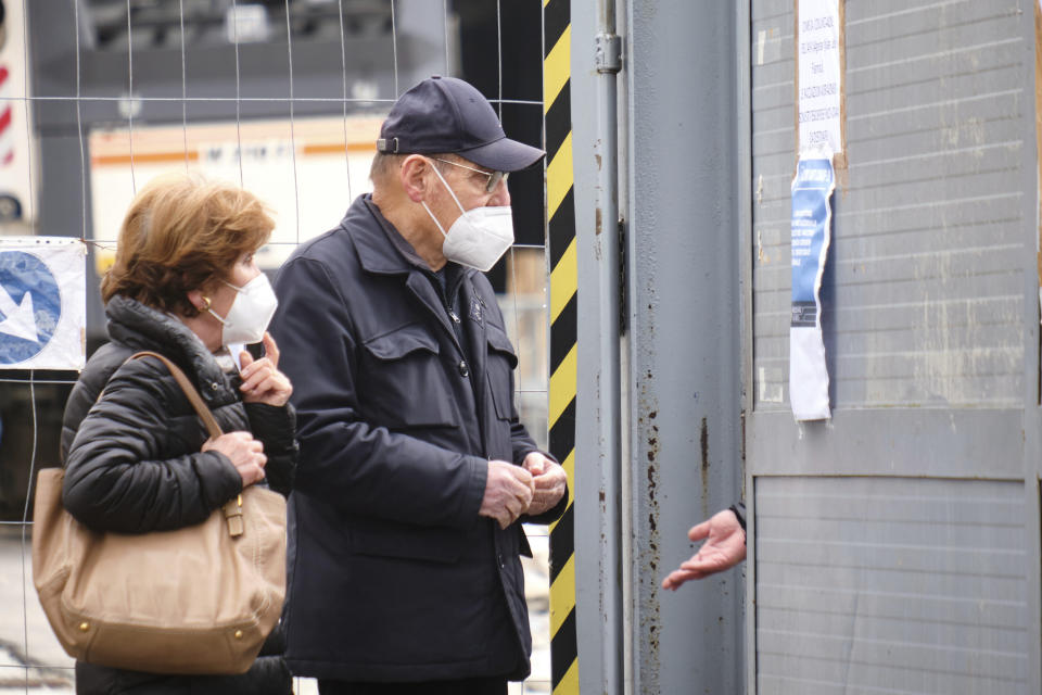 People ask for information at the vaccination center at the Nuvola in Rome, closed Tuesday, March 16, 2021, after the precautionary ban on the AstraZeneca vaccine. Italy, along with France and Germany, suspended the AstraZeneca vaccine temporarily as a cautionary measure, after news of suspect blood clots occurring after the administration of the vaccine. (Mauro Scrobogna/LaPresse via AP)