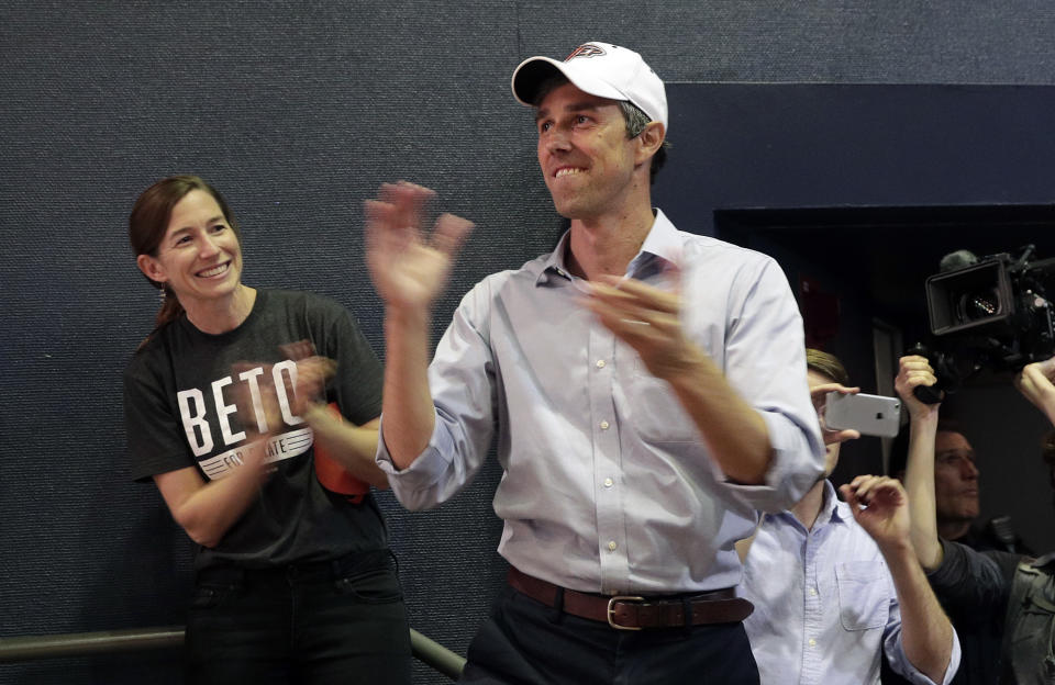 FILE - In this Nov. 5, 2018 file photo, then Rep. Beto O'Rourke, D-El Paso, with his wife Amy, left, arrives for a campaign rally in El Paso, Texas. Democratic presidential candidate Beto O’Rourke’s father-in-law, William Sanders, is worth at least $500 million and has helped make the former Texas congressman and his wife millionaires. He donated to O’Rourke’s bids for El Paso City Council, Congress, Senate and president. O’Rourke’s campaign says Sanders plays absolutely no role. Still, O’Rourke, who is known as a champion of little-guy values, might never have made it on the national stage without the help of the intensely private tycoon. (AP Photo/Eric Gay)