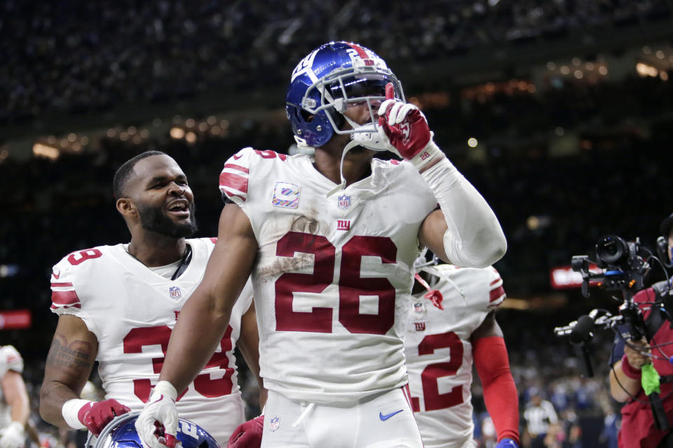 New York Giants running back <a class="link " href="https://sports.yahoo.com/nfl/players/30972" data-i13n="sec:content-canvas;subsec:anchor_text;elm:context_link" data-ylk="slk:Saquon Barkley;sec:content-canvas;subsec:anchor_text;elm:context_link;itc:0">Saquon Barkley</a> (26) celebrates his touchdown in overtime to defeat the New Orleans Saints in an NFL football game in New Orleans, Sunday, Oct. 3, 2021. The Giants won 27-21.(AP Photo/Brett Duke)