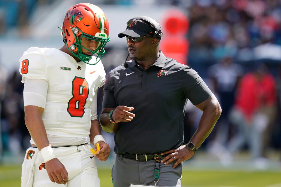 Florida A&M quarterback Jeremy Moussa (8) talks with head coach Willie Simmons during the first half of the Orange Blossom Classic NCAA college football game against Jackson State, Sunday, Sept. 4, 2022, in Miami Gardens, Fla. (AP Photo/Lynne Sladky)