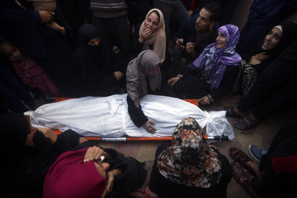 Palestinians mourn relatives killed in an Israeli bombardment of the Gaza Strip, outside a morgue in Khan Younis, on Monday, Dec. 11, 2023. (AP Photo/Mohammed Dahman)